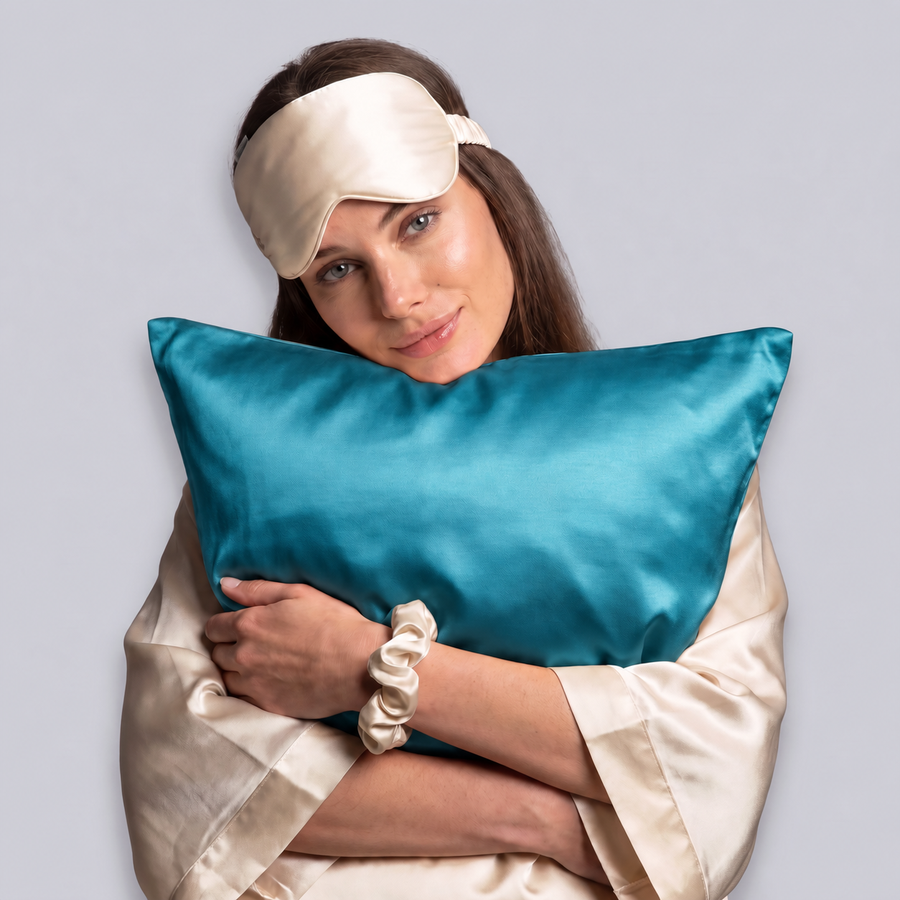 A woman hugging an Aveloor mulberry silk pillowcase in Atlantic