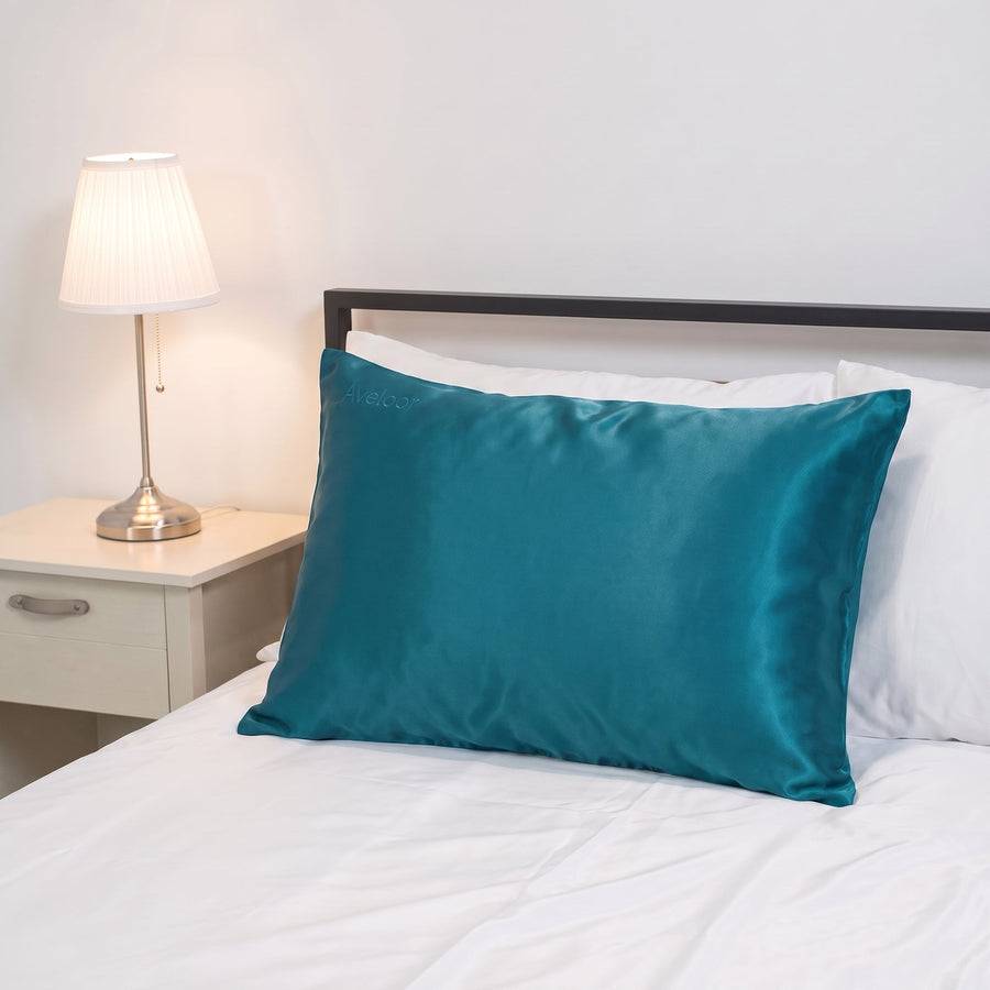 Aveloor 100% mulberry silk pillowcase in Atlantic on a made bed