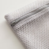 The Wash Bag - grey zip and thick honeycomb mesh close-up